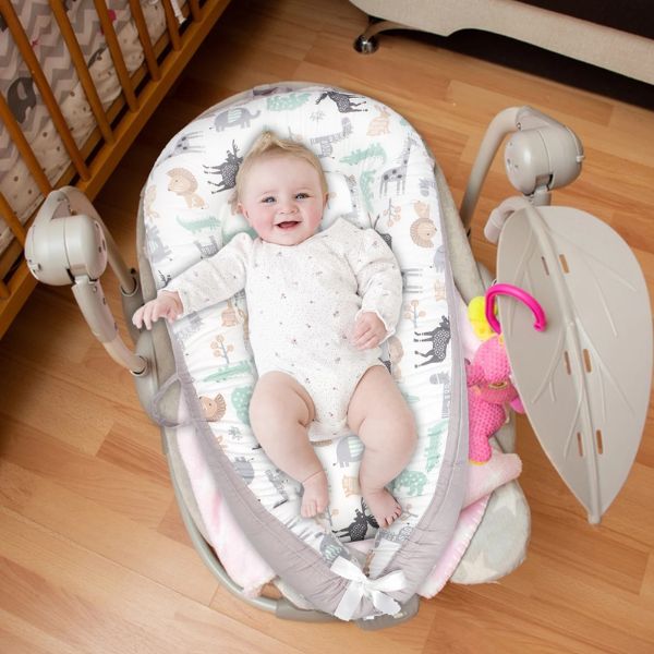 Bébé installé dans un réducteur de lit respirant