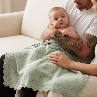 Couverture en tricot bébé vert sauge sur un bébé dans les bras de papa