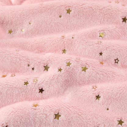 Motif étoiles pailletées sur le velours d'une couverture étoile pour bébé.