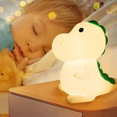 Petit garçon endormi avec veilleuse bébé dinosaure 