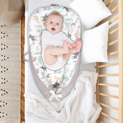 bebe allonge dans un reducteur de lit respirant en coton gris
