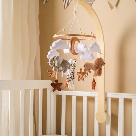 Mobile bebe suspendu sur support en bois au dessus du lit